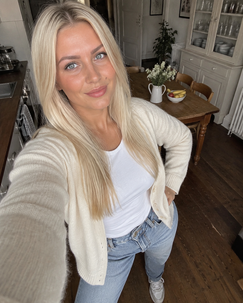 Smiling woman holding a coffee before a date